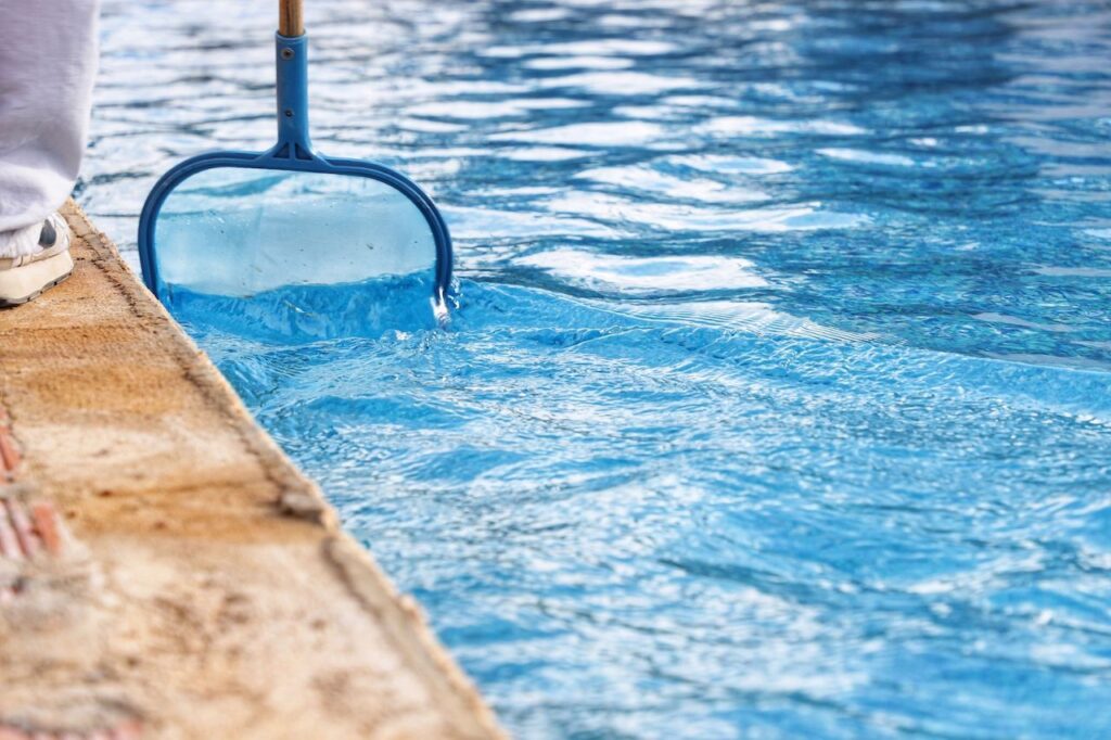 someone cleaning the pool for hurricane prep