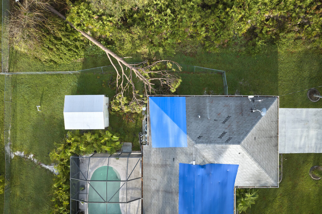 top view of a home and pool after a hurricane